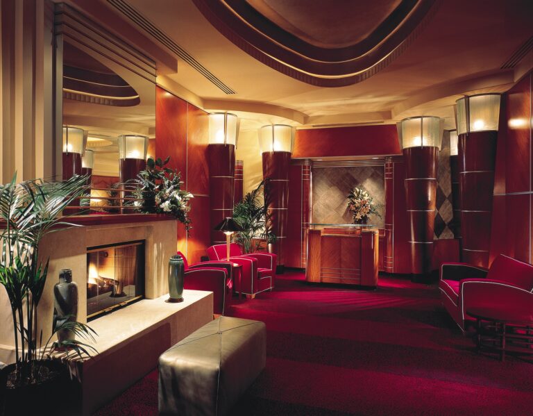 Lobby room, with red carpets, a fireplace, and high ceilings