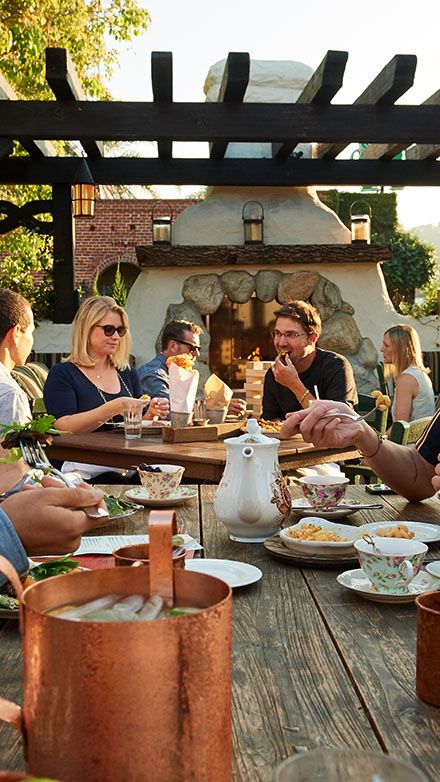 Diners at a table on an outdoor patio at Tam O'Shanter Los Angeles Steakhouse