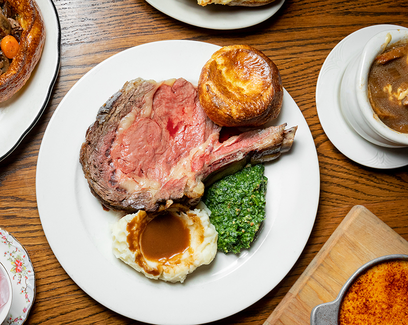 plate of prime rib with sides of mashed potatoes and creamed spinach