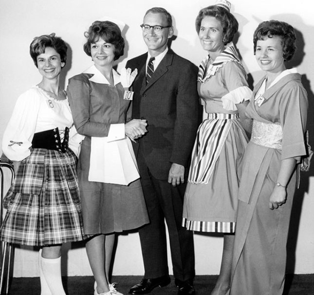 Vintage photo of Richard Frank with four servers from his various restaurants.