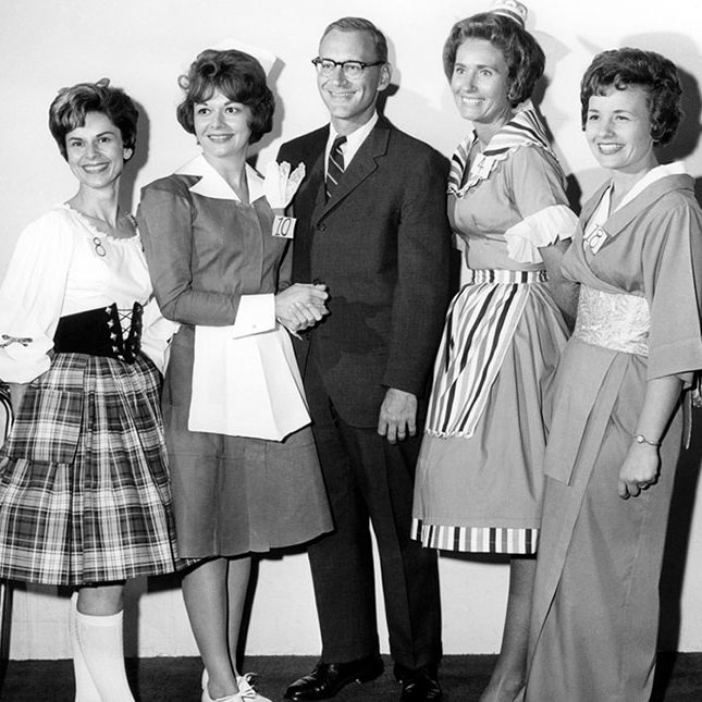 Vintage photo of Richard Frank with four servers from his various restaurants.
