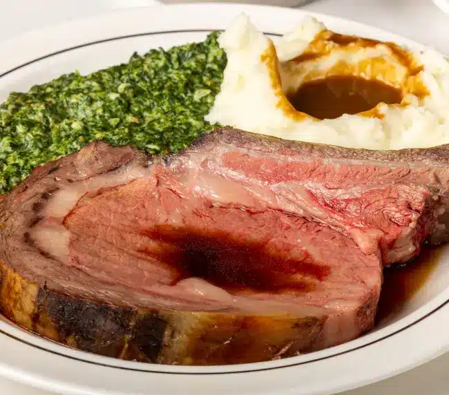 45-day dry-aged Linz Heritage Angus roasted prime rib served with au jus, Yorkshire pudding, and classic sides